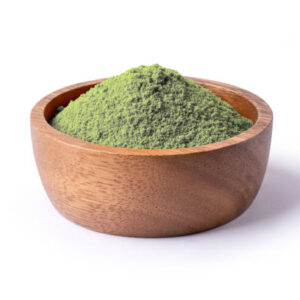Matcha green tea powder in wooden bowl isolated on white background.
