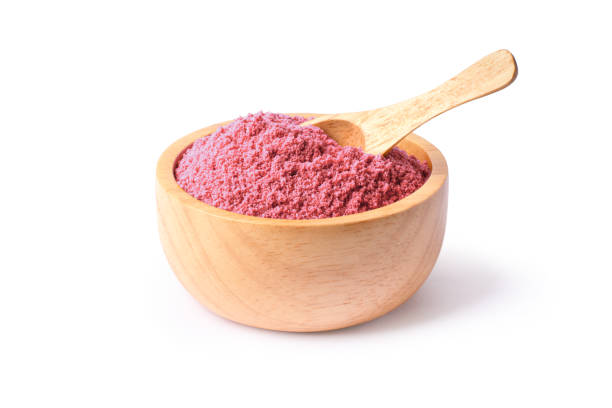 Bio fruit protein pink powder in wooden bowl isolated on white background.