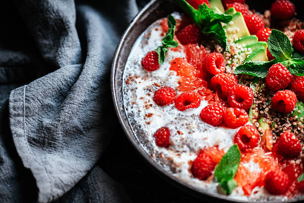 Healthy breakfast bowl with chia, avocado, linseed, grapefruit and raspberries