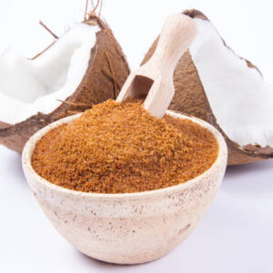 Closeup on a coconut with coconut sugar isolated on white background.